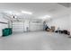 View of a 3 car garage with epoxy flooring, ample lighting, and three garage doors at 1025 Cheshire St, Port Charlotte, FL 33953