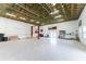 Spacious, open garage with a car lift and speckled epoxy floor, perfect for car enthusiasts or hobbyists at 1025 Cheshire St, Port Charlotte, FL 33953