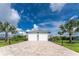 A beautifully maintained three-car garage with palm trees on a paved driveway at 1025 Cheshire St, Port Charlotte, FL 33953