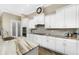 A spacious kitchen featuring white cabinets, granite countertops, stainless steel appliances, and a pantry at 1025 Cheshire St, Port Charlotte, FL 33953