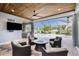 Covered lanai features outdoor seating with views of the pool and canal at 1025 Cheshire St, Port Charlotte, FL 33953