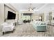 A large living room with wood floors, high ceilings, comfortable seating, and glass doors to the outside at 1025 Cheshire St, Port Charlotte, FL 33953