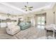 Open-concept living area with wood floors, high ceilings, comfortable seating, and access to other rooms at 1025 Cheshire St, Port Charlotte, FL 33953