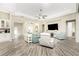 A living room boasting a neutral color palette, wood floors, high ceilings, and abundant natural light at 1025 Cheshire St, Port Charlotte, FL 33953