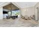 Open-concept living area with doors to the outside living area, dining space, and wood flooring at 1025 Cheshire St, Port Charlotte, FL 33953