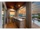 Outdoor kitchen featuring stainless appliances and views of the backyard pool at 1025 Cheshire St, Port Charlotte, FL 33953