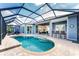 A screened-in swimming pool and patio with a wet bar and access to the house at 1025 Cheshire St, Port Charlotte, FL 33953
