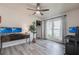 Bright and airy bedroom featuring laminate floors, a ceiling fan and large window with outdoor views at 10289 60Th N Cir, Pinellas Park, FL 33782
