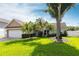 Charming single-story home featuring a well-manicured lawn, mature trees, and a two-car garage at 10289 60Th N Cir, Pinellas Park, FL 33782