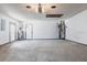 Spacious garage with concrete floor, white walls, storage, a water heater and access doors at 10289 60Th N Cir, Pinellas Park, FL 33782