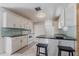 Well-lit kitchen featuring white cabinets, stainless appliances, and an eat-in island at 10289 60Th N Cir, Pinellas Park, FL 33782