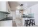 Bright kitchen with white cabinetry, granite countertops, and a tiled backsplash at 10289 60Th N Cir, Pinellas Park, FL 33782