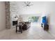 Bright living room with a stone fireplace, tile flooring, ceiling fan and sliding glass doors at 10289 60Th N Cir, Pinellas Park, FL 33782