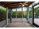 Relaxing outdoor patio featuring a Tiki Bar, ceiling fan, brick pavers and tropical foliage at 10289 60Th N Cir, Pinellas Park, FL 33782