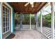 Relaxing outdoor patio featuring a ceiling fan, brick pavers, privacy lattice and tropical foliage at 10289 60Th N Cir, Pinellas Park, FL 33782