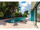 Private in-ground pool with brick paver surround and lush tropical landscaping at 10289 60Th N Cir, Pinellas Park, FL 33782