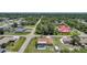 Expansive aerial view of a single Gathering home featuring a screened pool and lush, green landscaping at 1039 Marlene St, Port Charlotte, FL 33952