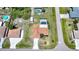 An aerial view showcases the property, highlighting its lush landscaping, pool, and proximity to surrounding neighborhood at 1039 Marlene St, Port Charlotte, FL 33952