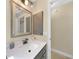 Bathroom features a vanity sink and a door leading to the toilet and shower at 1039 Marlene St, Port Charlotte, FL 33952