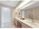 Bathroom with double sinks, a long vanity, and shower-tub combination at 1039 Marlene St, Port Charlotte, FL 33952