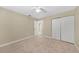 Bedroom with beige carpet, beige walls, and closet with folding doors at 1039 Marlene St, Port Charlotte, FL 33952