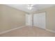 Bedroom with beige carpet, beige walls, and closet with folding doors at 1039 Marlene St, Port Charlotte, FL 33952
