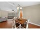 Dining room featuring modern chandelier and wood floors, adjacent to the living area at 1039 Marlene St, Port Charlotte, FL 33952