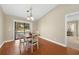Bright dining area with wood floors and sliding glass doors that lead to the screened lanai at 1039 Marlene St, Port Charlotte, FL 33952
