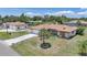 Charming single-story home with a well-manicured lawn, stone accents, and a spacious driveway leading to an attached garage at 1039 Marlene St, Port Charlotte, FL 33952
