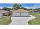 View of the property's oversized two car garage with driveway, providing ample parking in a beautifully maintained home at 1039 Marlene St, Port Charlotte, FL 33952