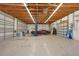 Spacious three-car garage with car lift, workspace, and storage solutions for the ultimate automotive enthusiast at 1039 Marlene St, Port Charlotte, FL 33952
