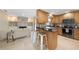 Open-concept kitchen with bar top, stainless appliances, and view of the living space at 1039 Marlene St, Port Charlotte, FL 33952