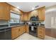 Well-lit kitchen featuring wood cabinets, stainless steel appliances, and tile floors at 1039 Marlene St, Port Charlotte, FL 33952