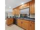 Charming kitchen featuring granite counters and wooden cabinets and stainless steel dishwasher at 1039 Marlene St, Port Charlotte, FL 33952