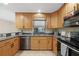 Updated kitchen featuring wooden cabinets, granite countertops and stainless steel appliances at 1039 Marlene St, Port Charlotte, FL 33952