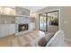 Cozy living room with decorative stone fireplace and sliding glass doors to the pool area at 1039 Marlene St, Port Charlotte, FL 33952