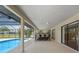 Outdoor patio with a pool and barstool seating facing the serene backyard at 1039 Marlene St, Port Charlotte, FL 33952