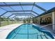 Bask in the sun by this pool, enclosed under a screened lanai for endless enjoyment of outdoor living and serene relaxation at 1039 Marlene St, Port Charlotte, FL 33952