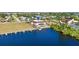 Aerial view of the waterfront home with a private dock, pool, and lush landscaping at 1217 Aqui Esta Dr # 5, Punta Gorda, FL 33950
