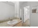 Bathroom vanity with mirror and a walk-in closet in the background at 1217 Aqui Esta Dr # 5, Punta Gorda, FL 33950