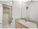 Bathroom vanity with mirror and a tiled walk-in shower in background at 1217 Aqui Esta Dr # 5, Punta Gorda, FL 33950
