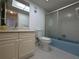 Bathroom featuring vanity, toilet and shower/tub combo with sliding glass door at 1217 Aqui Esta Dr # 5, Punta Gorda, FL 33950