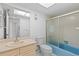 Bathroom featuring vanity, toilet and shower/tub combo with sliding glass door at 1217 Aqui Esta Dr # 5, Punta Gorda, FL 33950