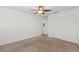 Bedroom featuring neutral carpet and ceiling fan with an adjacent closet at 1217 Aqui Esta Dr # 5, Punta Gorda, FL 33950