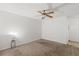 Bedroom featuring neutral carpet, ceiling fan, and accent table at 1217 Aqui Esta Dr # 5, Punta Gorda, FL 33950