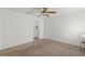 Bright bedroom with neutral carpeting, ceiling fan, and access to bath at 1217 Aqui Esta Dr # 5, Punta Gorda, FL 33950