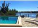 Picturesque community pool overlooking the canal, with lounge chairs for relaxing by the water at 1217 Aqui Esta Dr # 5, Punta Gorda, FL 33950