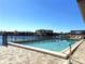 Tranquil community pool offering a refreshing escape with views of the surrounding waterfront and buildings at 1217 Aqui Esta Dr # 5, Punta Gorda, FL 33950