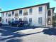 Exterior view of the building with parking. A well-maintained facade enhances curb appeal at 1217 Aqui Esta Dr # 5, Punta Gorda, FL 33950