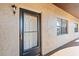 Exterior view of the building's front door with the unit number and textured walls at 1217 Aqui Esta Dr # 5, Punta Gorda, FL 33950